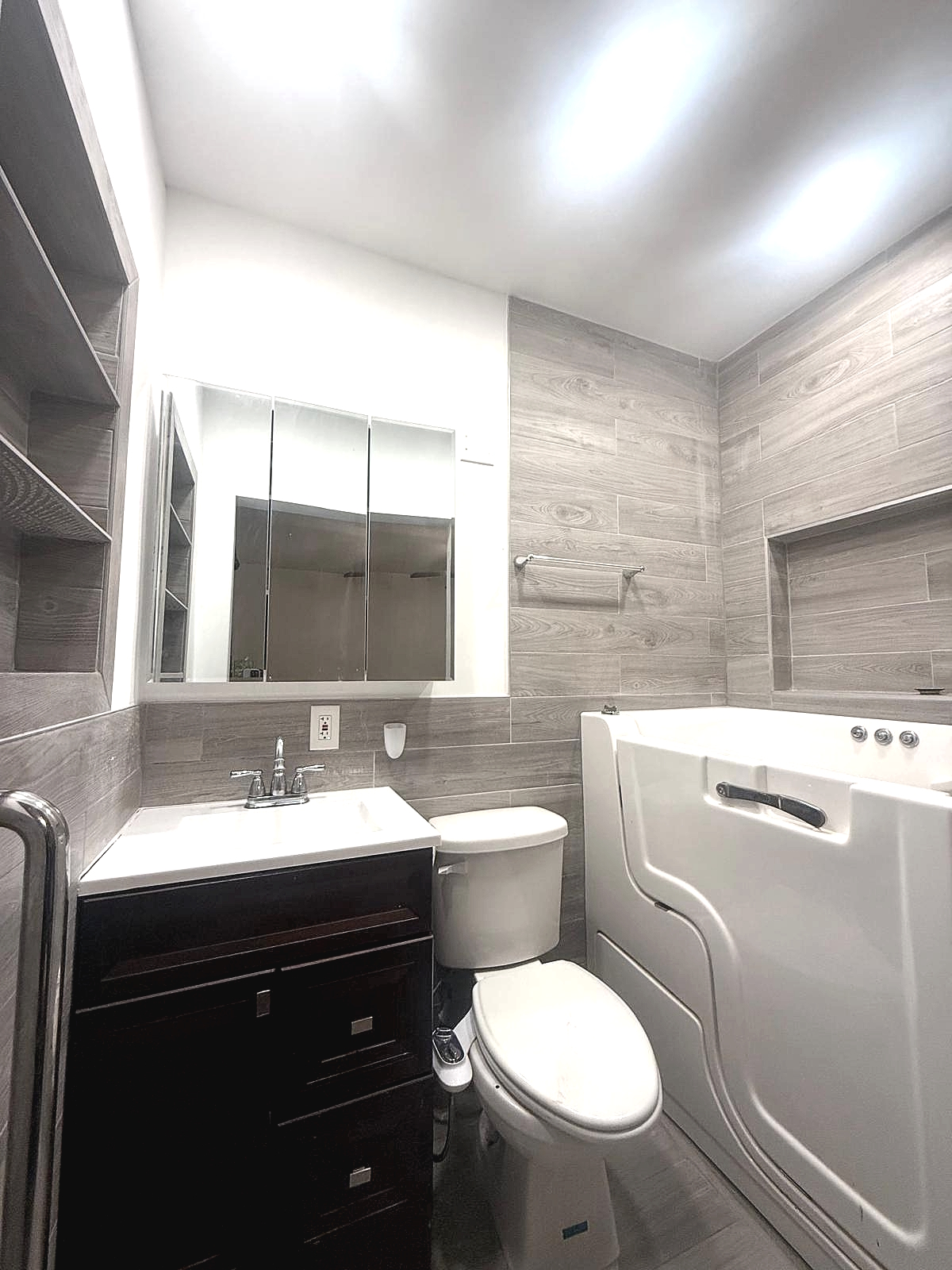 Bathroom with tile surround and storage